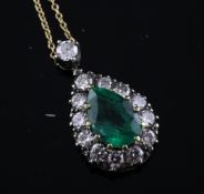 A gold, emerald and diamond set pear shaped pendant, with pear shaped emerald bordered by