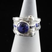 A 1940`s platinum, synthetic sapphire and diamond dress ring, of scroll and geometric design, set