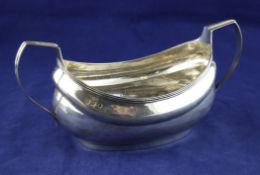 A George III Irish silver boat shaped sugar bowl, with reeded border and handles, IB?, Dublin, 1807,