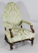 A provincial French walnut framed open armchair, with shaped back, scroll arms and legs and castor