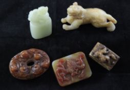 A group of five Chinese jade and chalcedony carvings, the first a celadon green seal with lion-dog