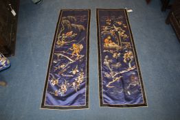 A pair of Chinese embroidered silk panels of fishermen and a scholar, both amid trees and flowers on