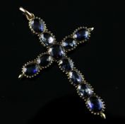 A gold and sapphire set cruciform pendant, 2in. Starting Price: £480