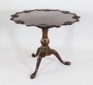 An 18th century mahogany tilt top supper table, the top with carved oyster shell border, with
