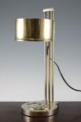 A French Art Deco adjustable brass table lamp, the circular base decorated with a monkey,