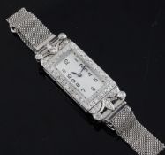 A lady`s 1960`s platinum and diamond cocktail watch, of rectangular form, with diamond set bezel and