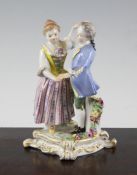 A Meissen group of a boy and girl, early 20th century, in 18th century dress, the scrollwork base