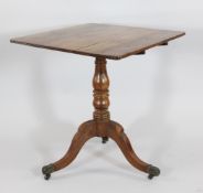 A 19th century yew wood tripod table, with tilt top, on turned column and brass caster feet, W.1ft