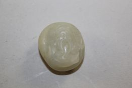 A Chinese pale celadon jade carving, decorated with the head of a bearded immortal 1in. Starting