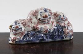 A Chinese underglaze blue and copper red brush rest, 18th / 19th century, modelled as a Buddhist