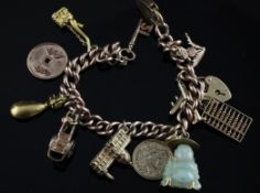 A 1960`s 9ct gold curb link charm bracelet, hung with eleven assorted charms, gross 42.3 grams.