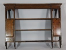 A late 18th century oak dresser rack, fitted with open shelves, cupboard doors and drawers, W.4ft