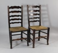 A matched set of six Lancashire ladderback dining chairs, with rush seats, turned stretchers and