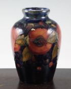 A Moorcroft `Pomegranate` ovoid vase with rounded rim, c.1920, on dark blue ground, inscribed `W.