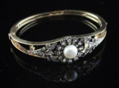 A gold, cultured pearl and diamond set stiff bracelet, of foliate design, with open frame