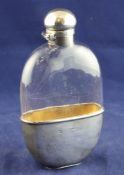 A Victorian silver mounted oval plain glass hip flask, with engraved armorials, monogram and