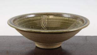 A Studio stoneware olive green glazed bowl, with incised circle and curved line decoration,