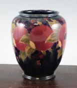 A Moorcroft `Pomegranate` ovoid vase, c.1916, with varied blue green ground, inscribed `W Moorcroft`