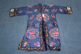 A Chinese embroidered silk lady`s summer robe, decorated with flower, butterfly and bat medallions