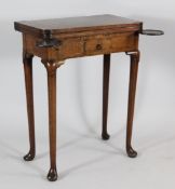 A George II walnut folding card table, with slide out counter wells and small single frieze