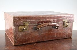 A George V crocodile skin travelling toilet case by Mappin & Webb, the fitted interior containing