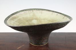 Chris Carter (1945-). A large stoneware footed bowl, the rim slightly compressed, with shiny green