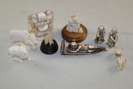 A group of Japanese and South Asian ivory carvings, including two netsuke of standing farmers, a