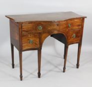 A George III mahogany serpentine side table, with single drawer, two smaller drawers, tapered legs