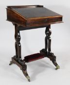A Victorian rosewood davenport, on pierced scroll trestle ends with downswept legs and brass