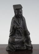 A Chinese bronze seated figure of a sage, holding a gourd in his right hand, 7.5in. Starting