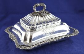 A George IV silver entree dish and cover by Paul Storr, of shaped rectangular form, with two