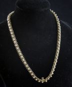 An Edwardian gold and split pearl set necklace, with chevron style links, lacking pendant drop,