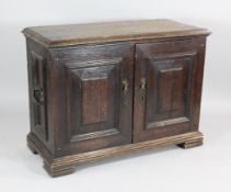 A late 17th / early 18th century oak cupboard, fitted an arrangement of drawers, enclosed by two