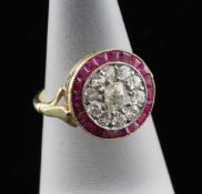 A 1940`s 18ct gold, ruby and diamond target dress ring, the central stone bordered by concentric