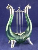 A Victorian silver mounted Stourbridge green glass double ended decanter modelled as a lyre, by