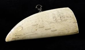 A 19th century scrimshaw whale`s tooth, decorated with a whaling scene, 6.5in. Starting Price: £560