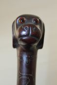 An unusual Victorian dogs head walking cane, carved with a frog, snake and various dogs heads, glass