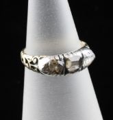 An early 19th century gold and three stone diamond ring, set with old mine cut stones, size H.