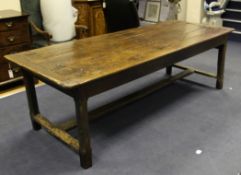 An 18th century oak refectory table, with plank top, square section legs united by H frame