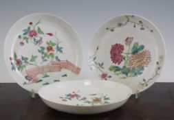 Three Chinese famille rose saucer dishes, Qianlong period, two painted with a bird amid peonies in a