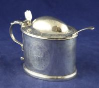 A George III silver oval mustard with blue glass liner and later mustard ladle, with engraved
