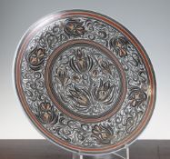Julia Carter Preston. A pottery floral decorated charger, decorated with Persian style flowers and