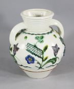 A large Zsolnay pottery twin handled vase, of ovoid form, moulded and painted in colours with