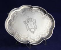 A George III silver shaped oval teapot stand, with engraved armorial and engraved foliate