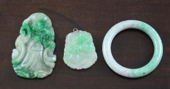 Three items of Chinese jadeite, comprising two pendants, one carved as a figure of Shou Lao