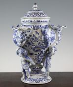 A French faience multiple tulip vase, the ogee shaped body modelled with three lizards and cherubs