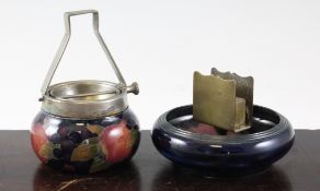 A Moorcroft `Pomegranate` ashtray and matchbox holder, c.1920; the ashtray in mottled cobalt and