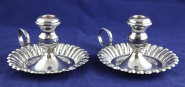 A pair of mid 20th century Egyptian silver chambersticks, of circular fluted form, with ring