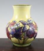 A Moorcroft `Orchid` squat baluster vase, c.1953-78, on yellow ground, inscribed `Moorcroft` mark,