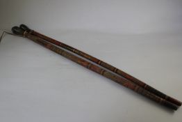 Two carved and polychrome decorated walking canes, probably South American, with horn handles